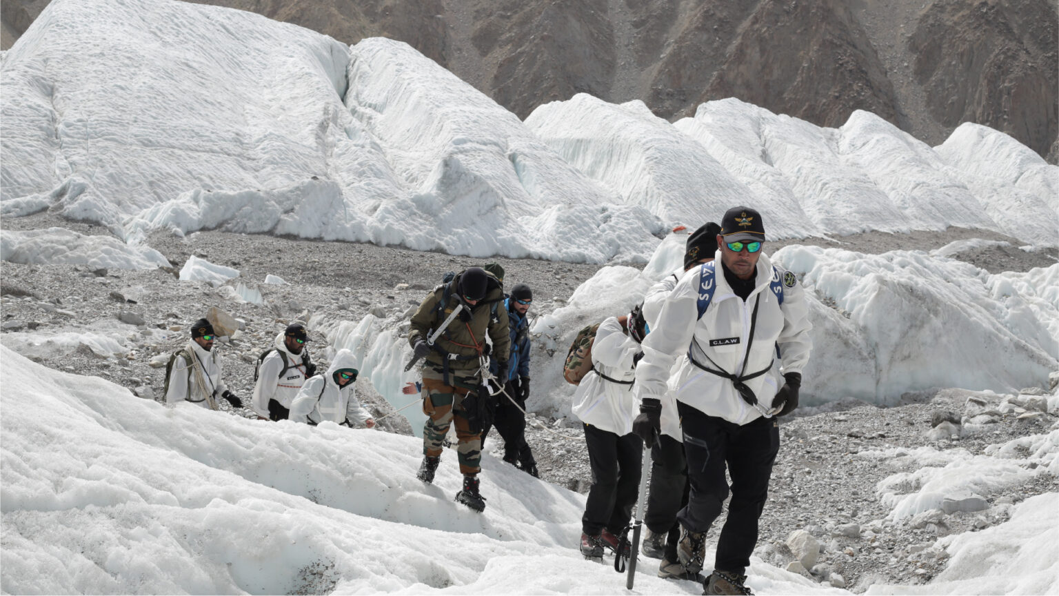 People in special gear in a high altitude area covered in ice and snow